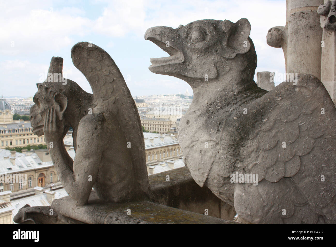 Notre Dame Cathedral, Paris.  Chimeras 6, the Stryge, and 7, open-beaked bird, on the balcony Stock Photo