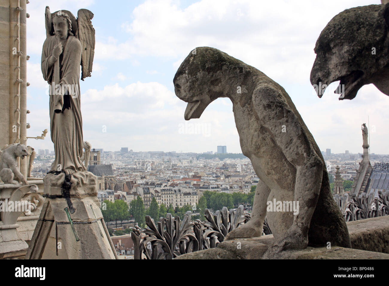 Notre Dame Cathedral, Paris.  Chimeras 39,  & 40 on the balcony, with trumpeting Angel Stock Photo