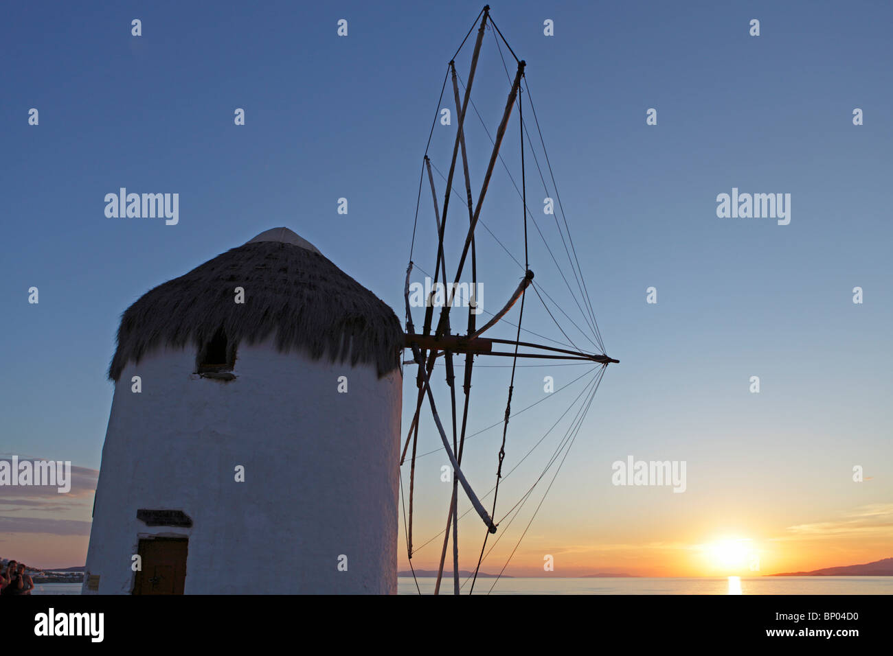 sunset beside a traditional windmill, Mykonos Town, Mykonos Island, Cyclades, Aegean Islands, Greece Stock Photo