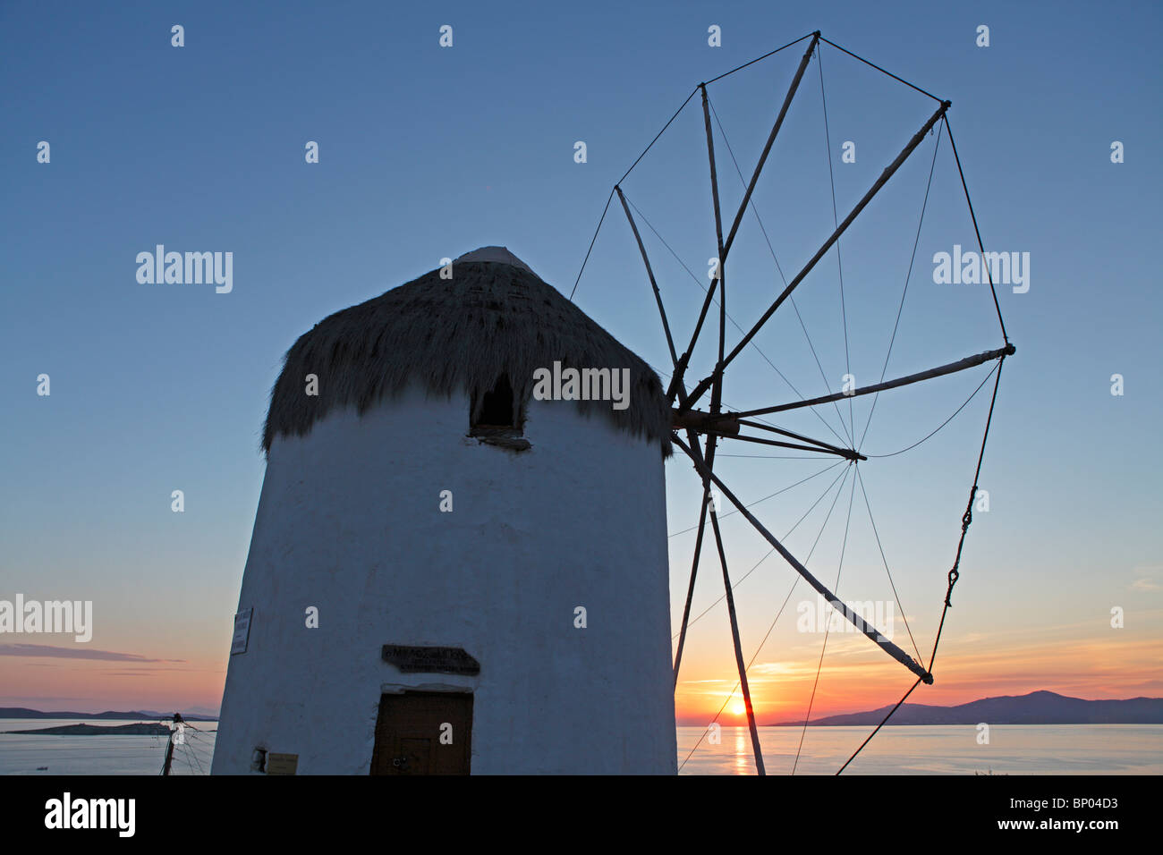sunset beside a traditional windmill, Mykonos Town, Mykonos Island, Cyclades, Aegean Islands, Greece Stock Photo