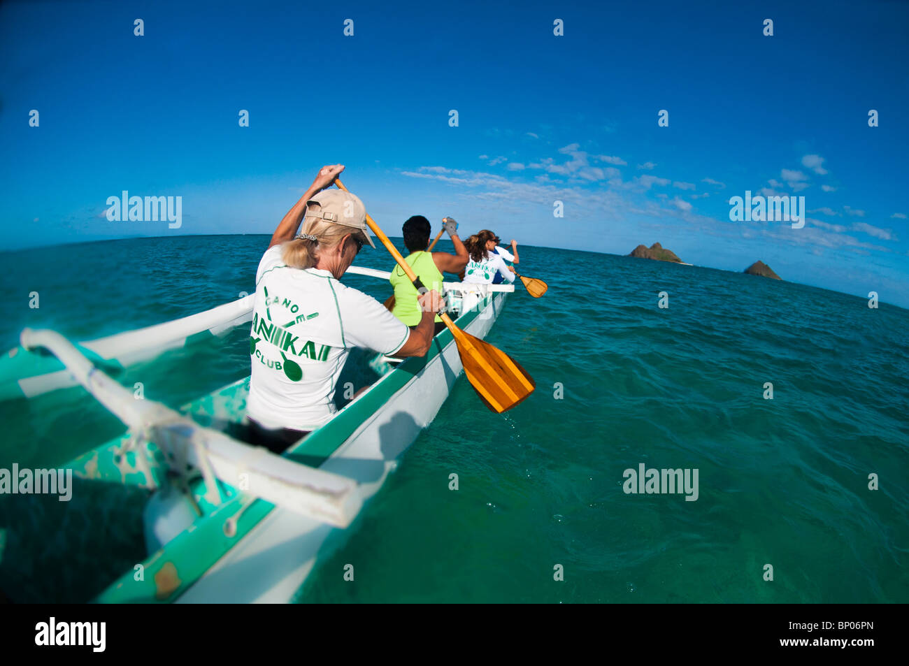 Women paddling outrigger canoe, Kailua Bay, Oahu, Hawaii, USA Stock