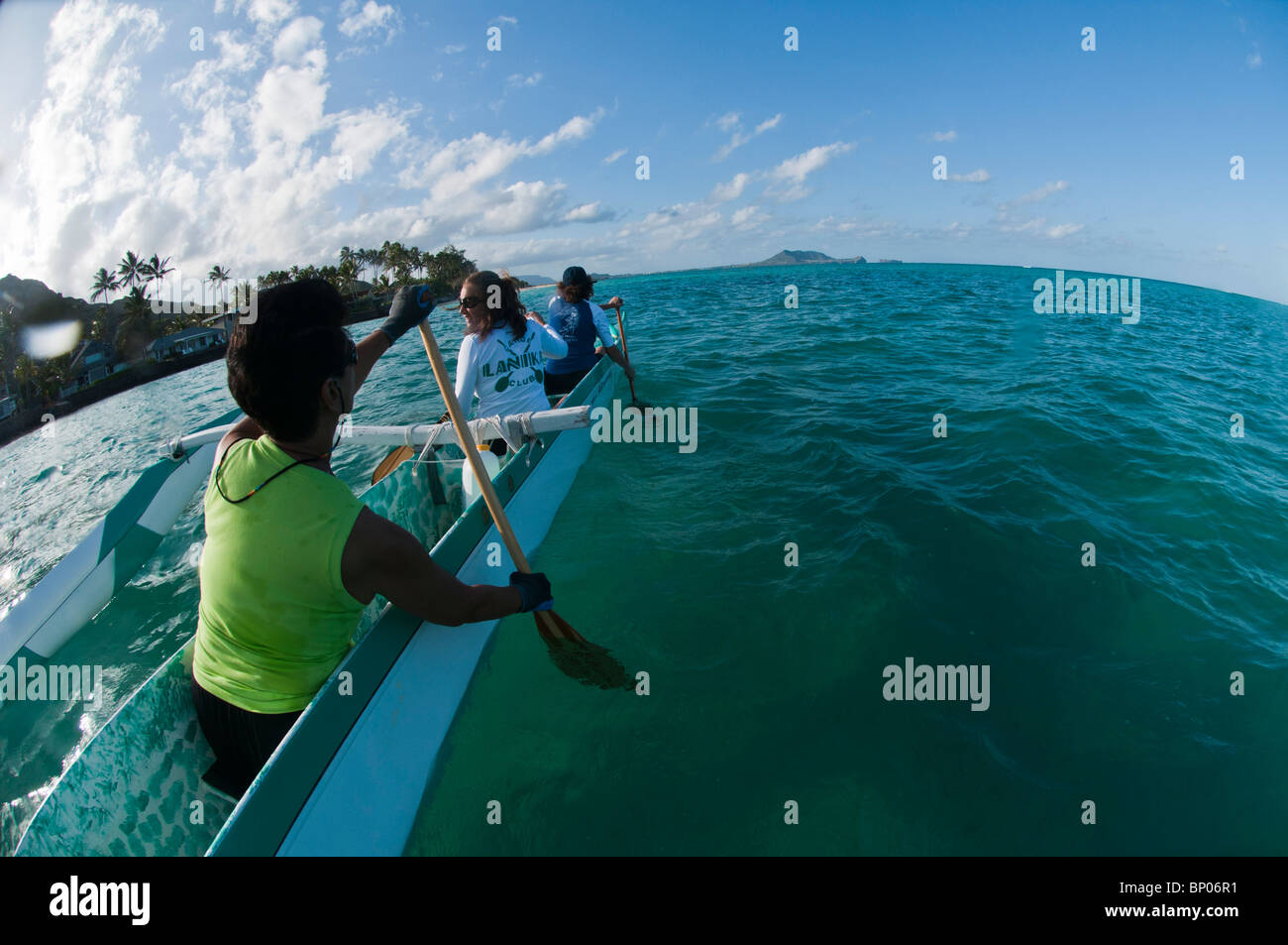 Women paddling outrigger canoe, Kailua Bay, Oahu, Hawaii, USA Stock