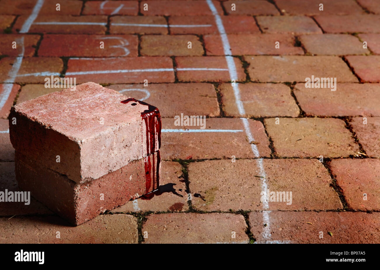 Blood covered brick at scene of crime or accident with numbered chalk