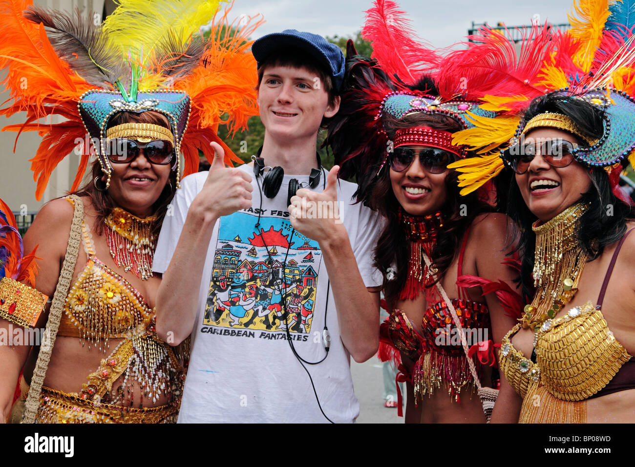 Caribana performers posing with young visitor after ScotiaBank Parade on Lake Shore Boulevard Toronto on July 31 2010. Stock Photo