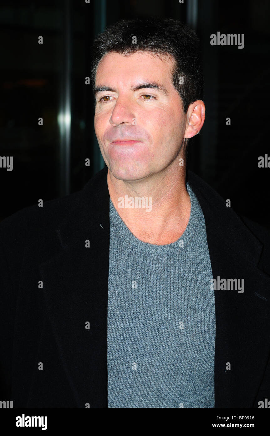 Simon Cowell Pulls Funny Faces As Arrives Back At His Manchester Stock Photo Alamy