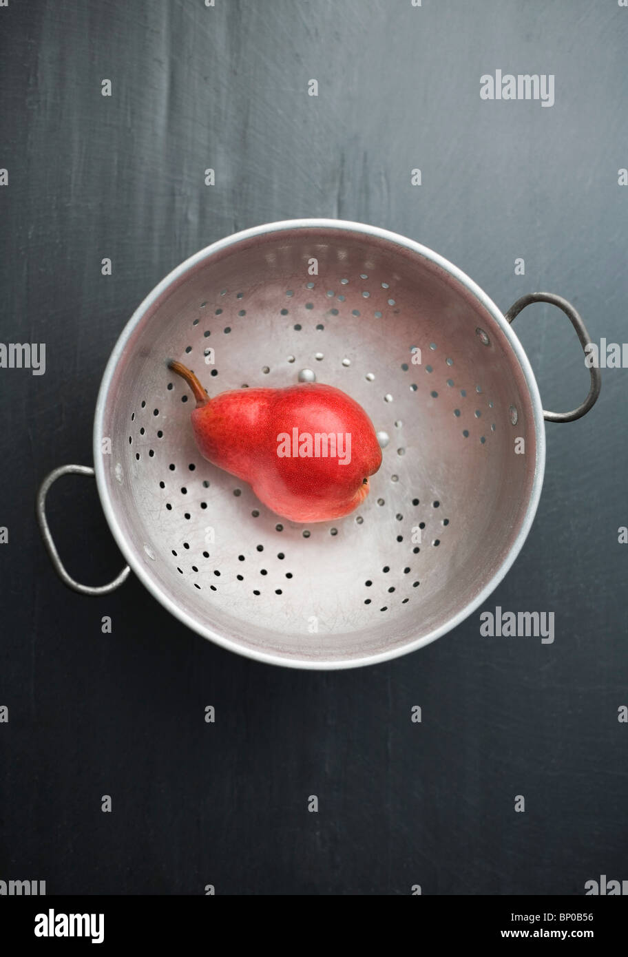 Red pear on a colander Stock Photo