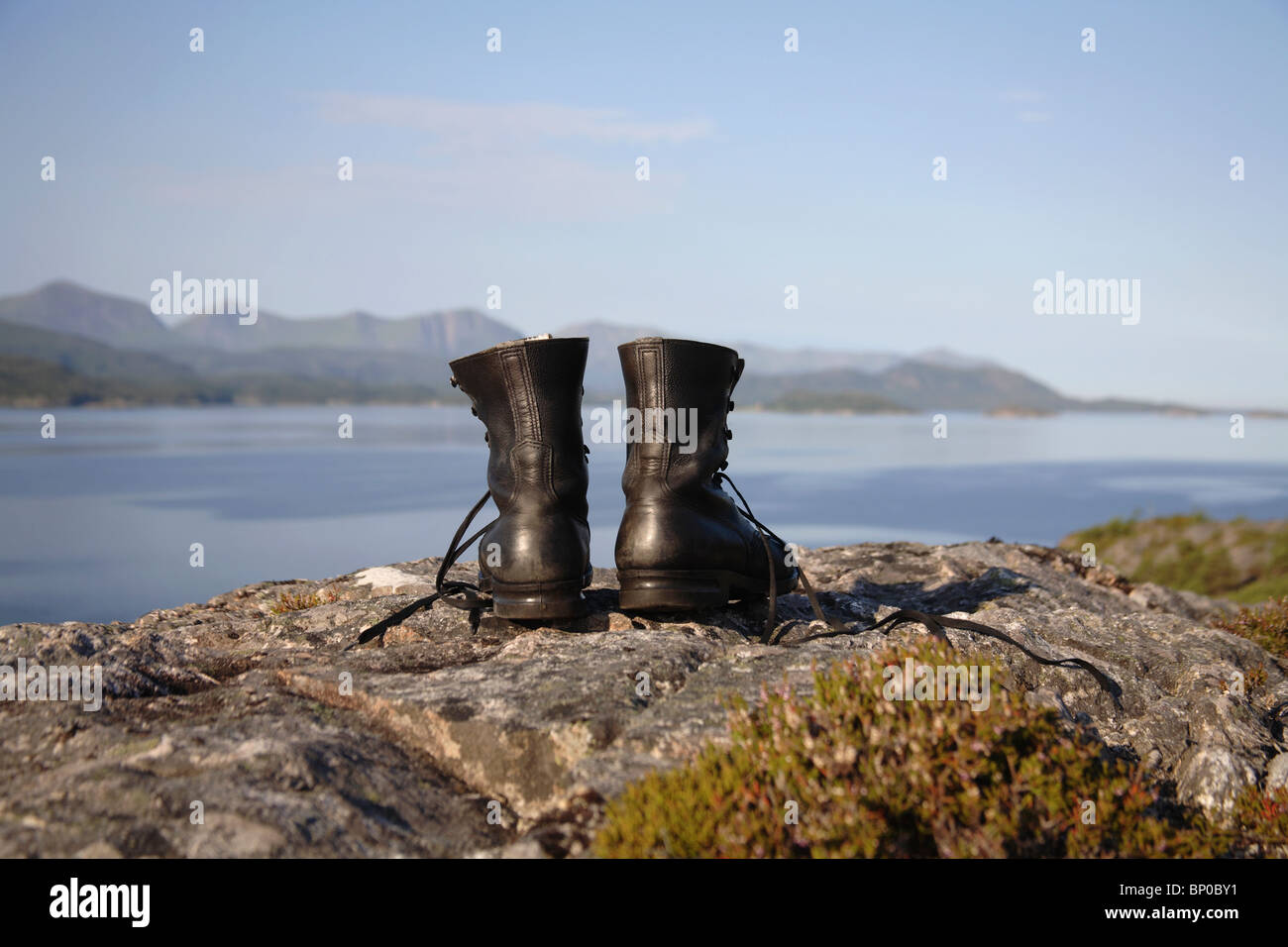 Hiking boots on cliff by the sea Stock Photo Alamy
