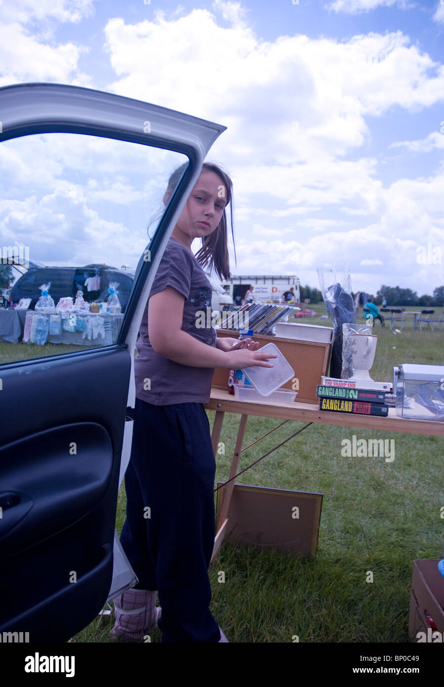 a child counts money at a car boot sale stall at barleylands Essex Stock Photo