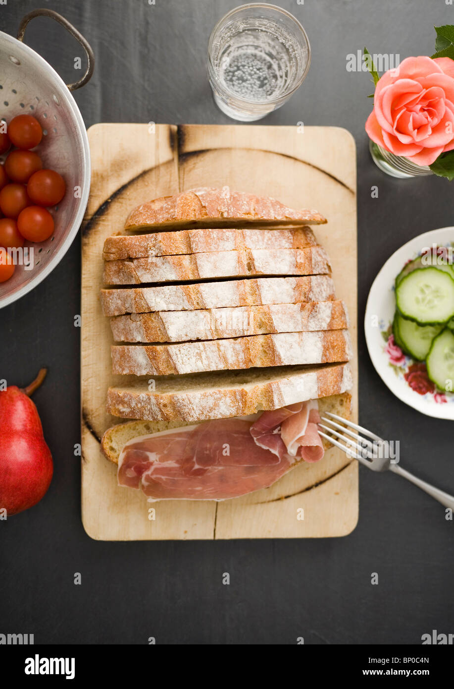 Bread on wooden board with ham Stock Photo