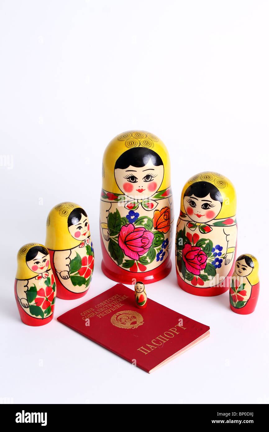 Matryoshka dolls family surrounding USSR passport Stock Photo