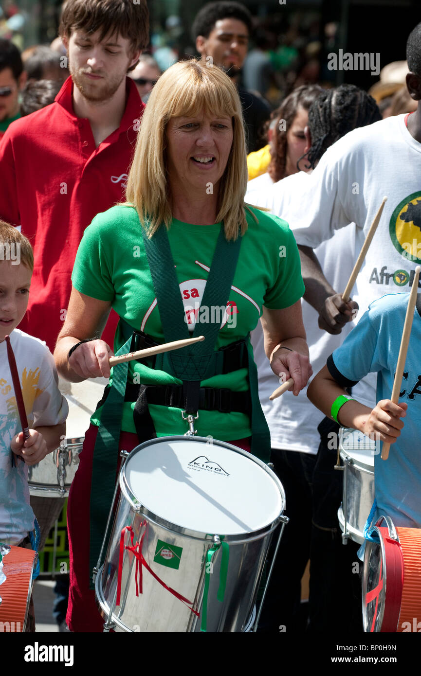 Woman drumming at a Brazilian festival at the Southbank in London Stock Photo