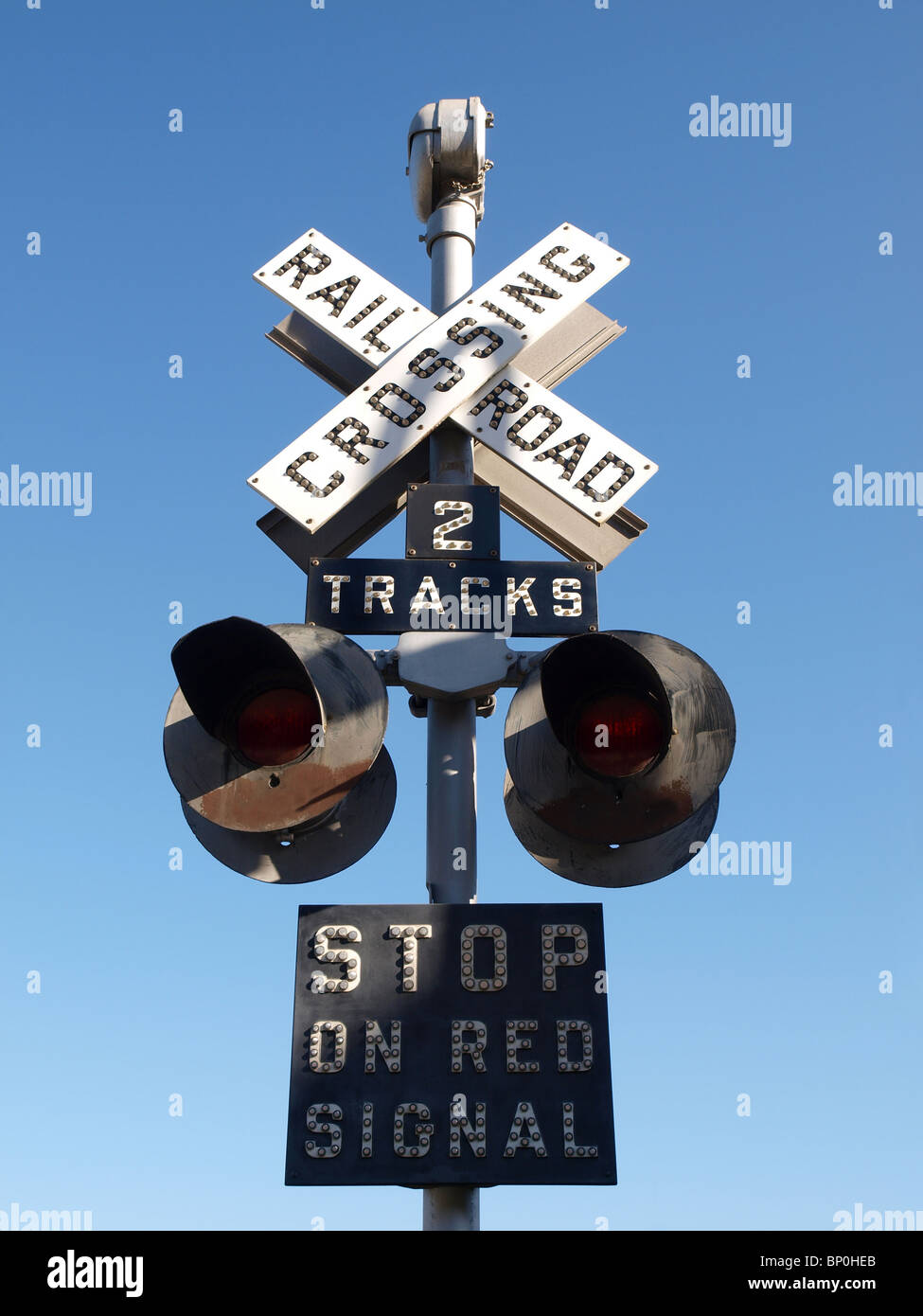 Vintage railroad signal warns motorists to stop. Stock Photo