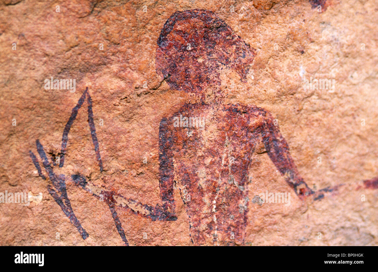 Libya, Fezzan, Jebel Akakus. A painted figure lies hidden on the walls of Graibu, one of Wadi Teshuinat's caves Stock Photo