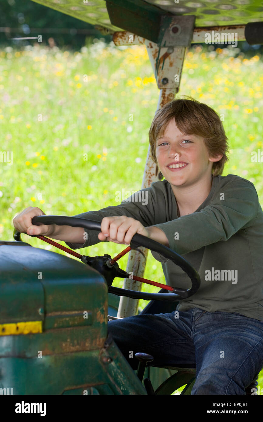 Boy on truck, proud Stock Photo - Alamy