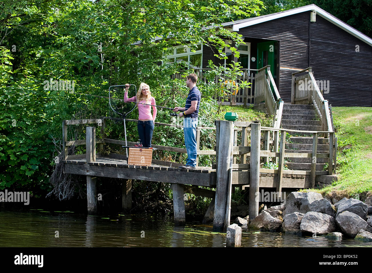 Northern Ireland, Fermanagh, Enniskillen. A couple fishing on Lough Erne from the chalets at the