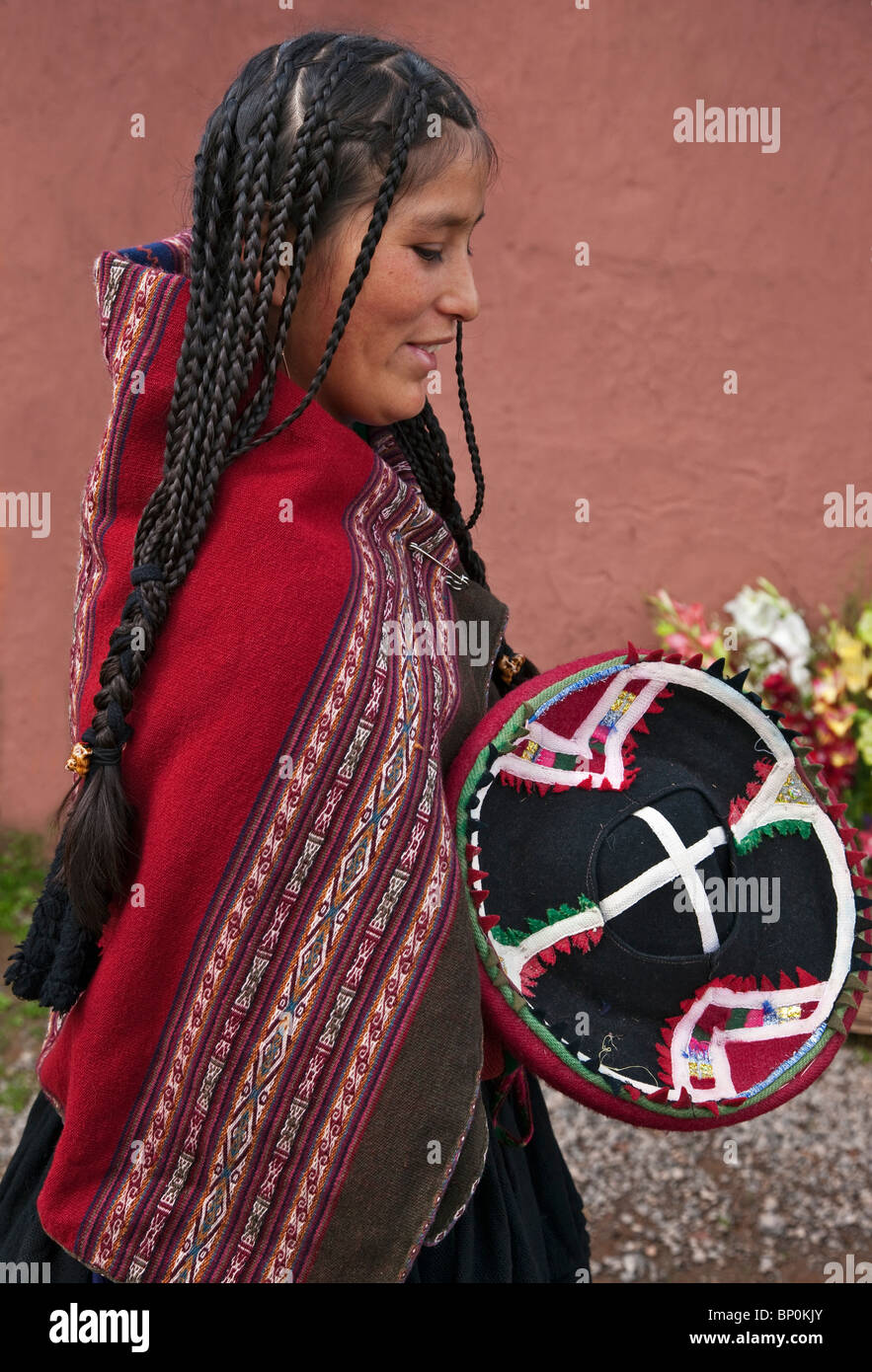 Peru, A young woman in traditional Indian costume with long braided