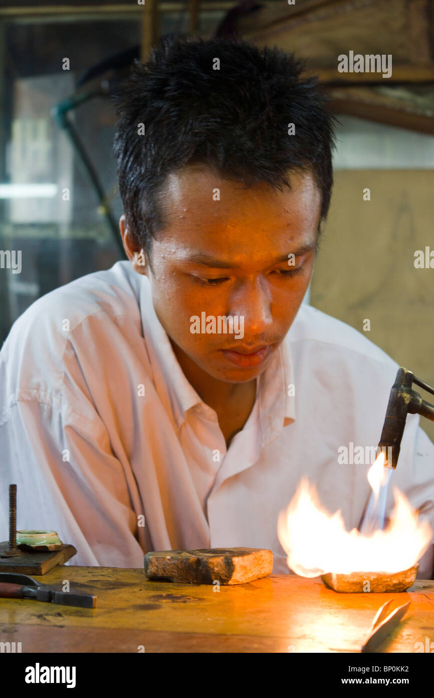 silversmith melting silver with blow torch at Ywama village, Inle lake, Myanmar Burma Stock Photo