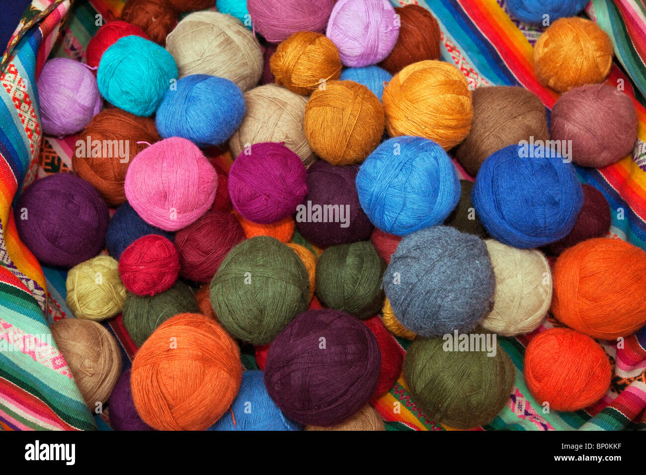 Peru, Balls of wool dyed in bright colours by Chinchero weavers using vegetable dyes in the traditional manner. Stock Photo