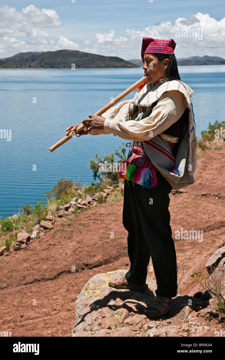 Peru, A Quechua-speaking man plays his flute on Taquile Island. The 7-sq-km island has a population of around 2,000 people. Stock Photo