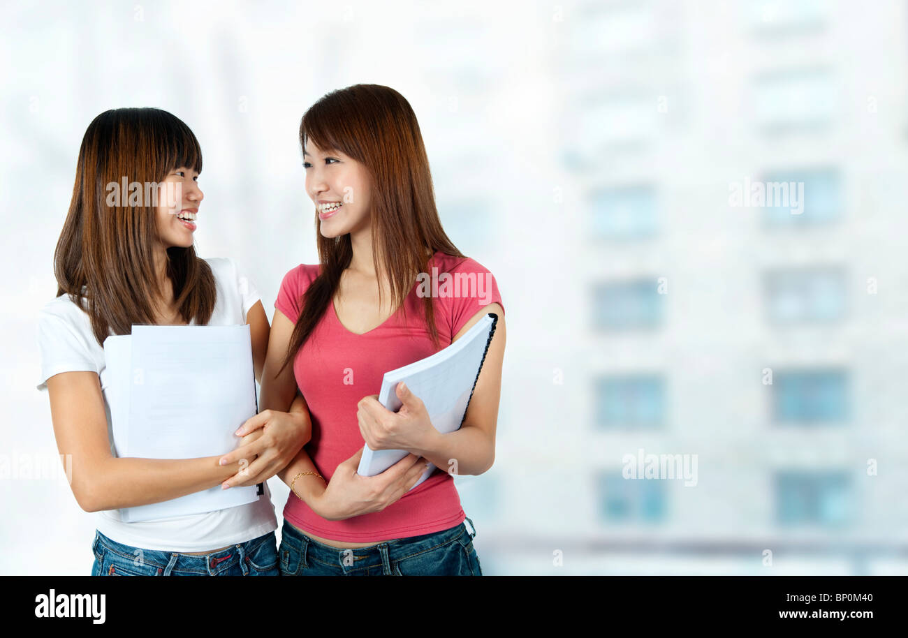 Happy Asian students with books in school campus Stock Photo - Alamy