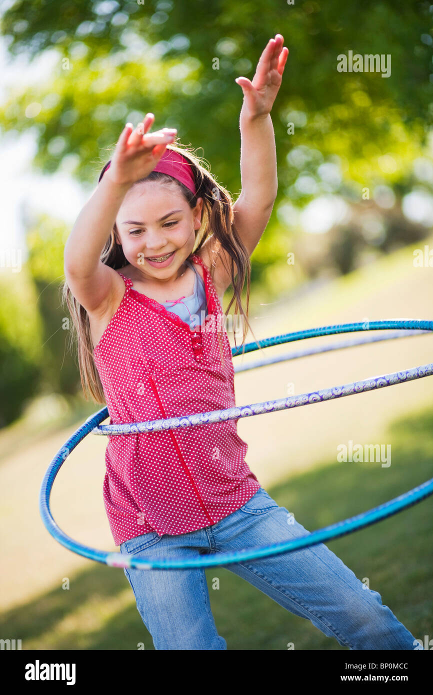 Young girl playing with hula hoop Stock Photo Alamy