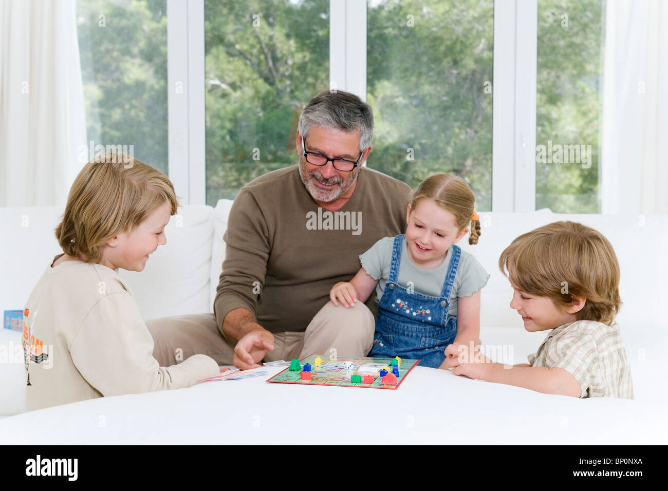 Family playing monopoly Stock Photo - Alamy