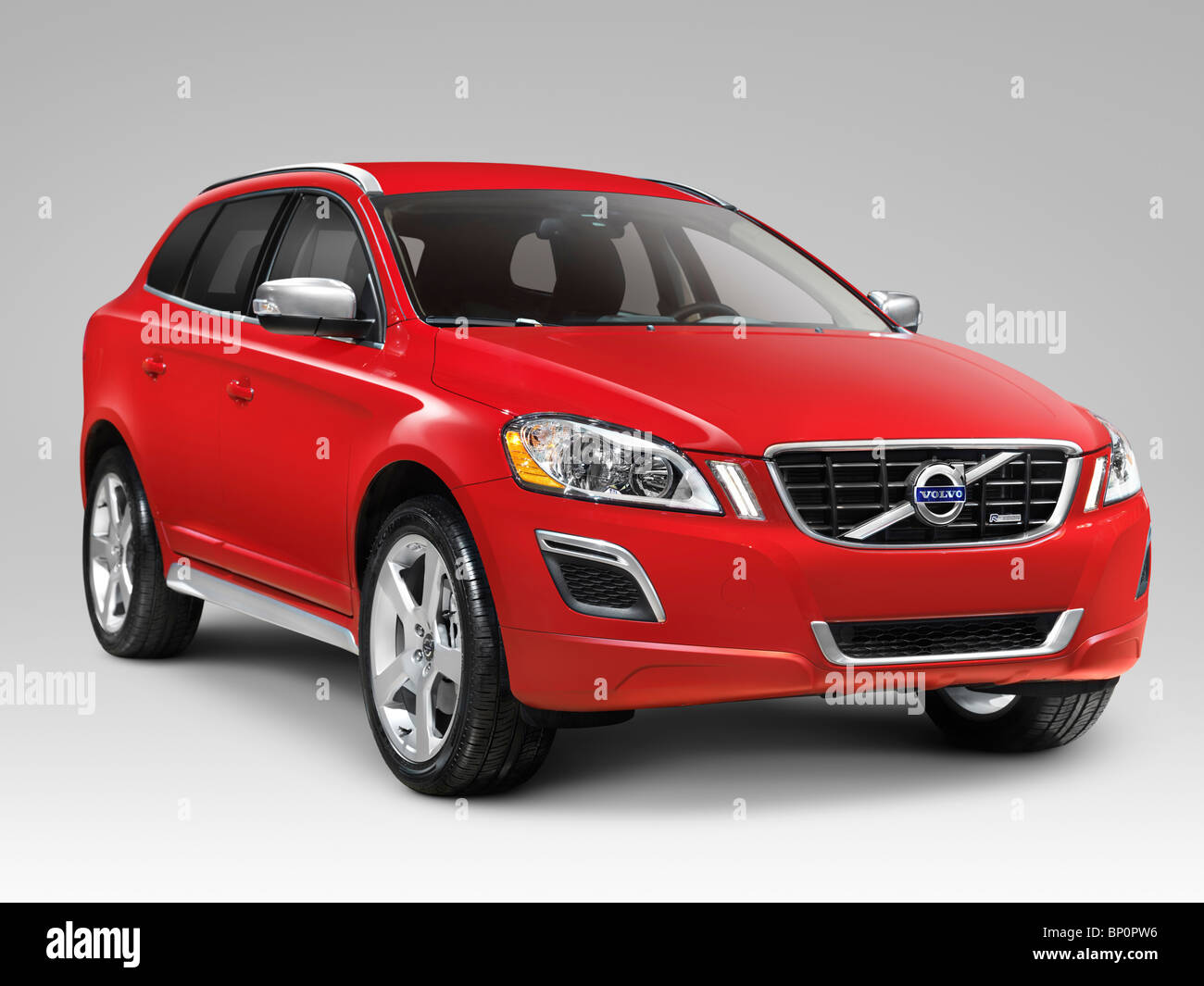 License available at MaximImages.com - Red 2010 Volvo XC60 T6 AWD R-Design midsize SUV the safest car to date. Isolated on gray background with clippi Stock Photo