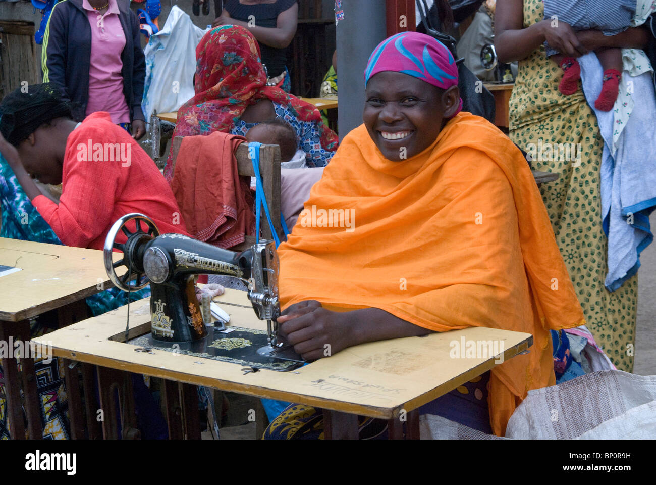 Rwanda, smiling woman using sewing machine Stock Photo Alamy