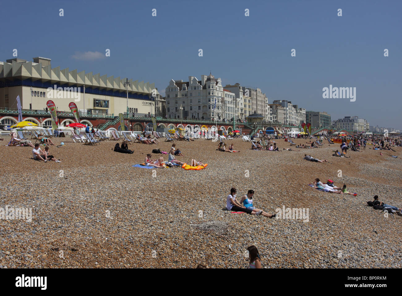 Bank Holiday tourists and locals enjoying beautiful weather on Brighton beach. Stock Photo