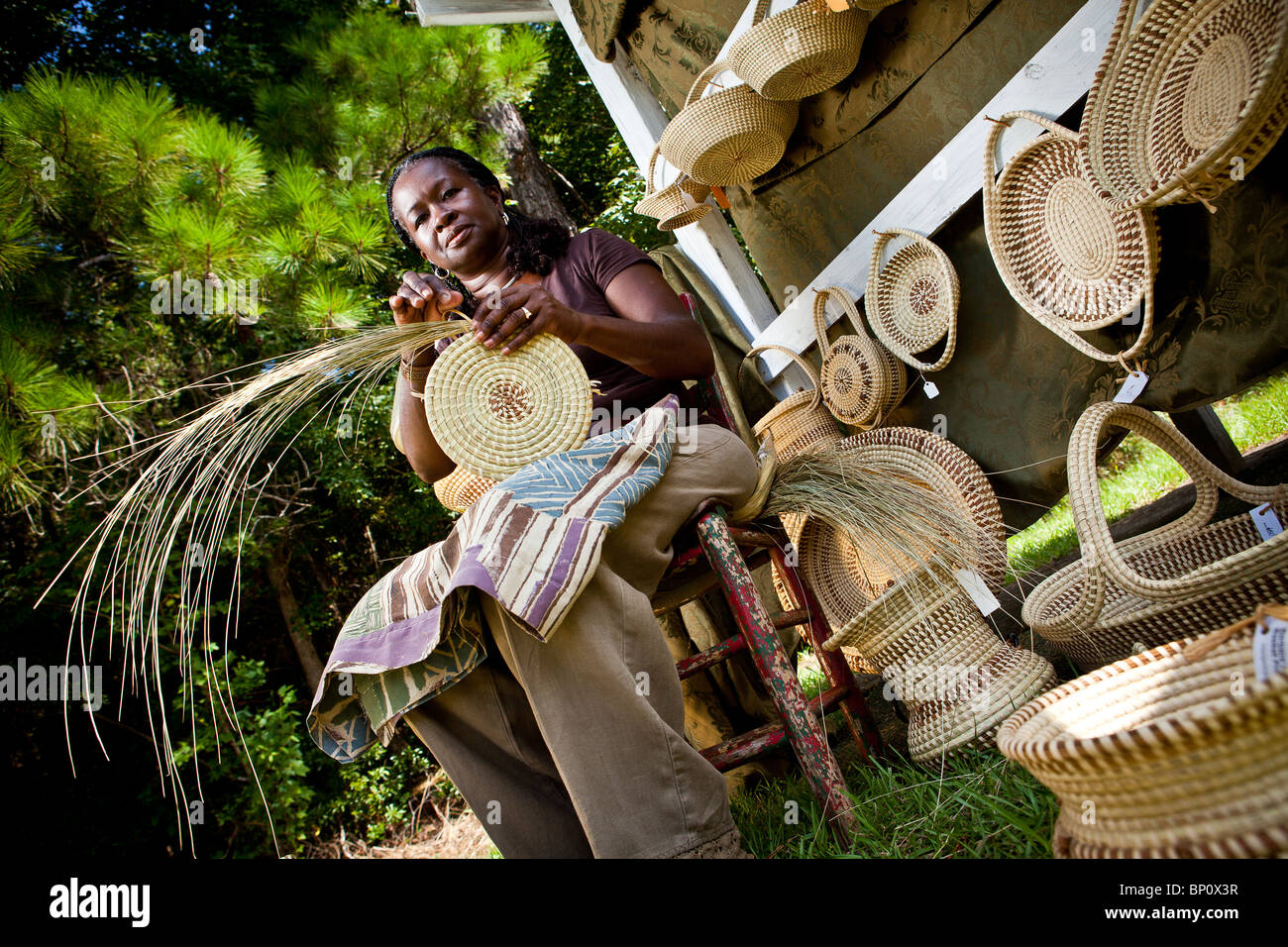 Barbara Manigault, a Gullah sweet grass basket weaver at her stand in