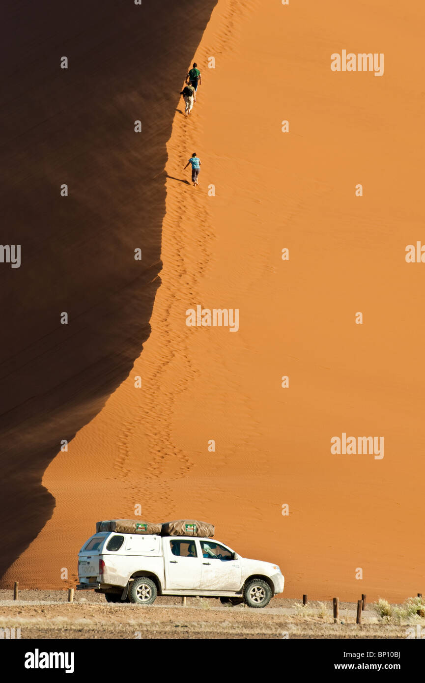 Tourists ascending dune 45 at Sossusvlei in Naukluft Park Central Namib ...