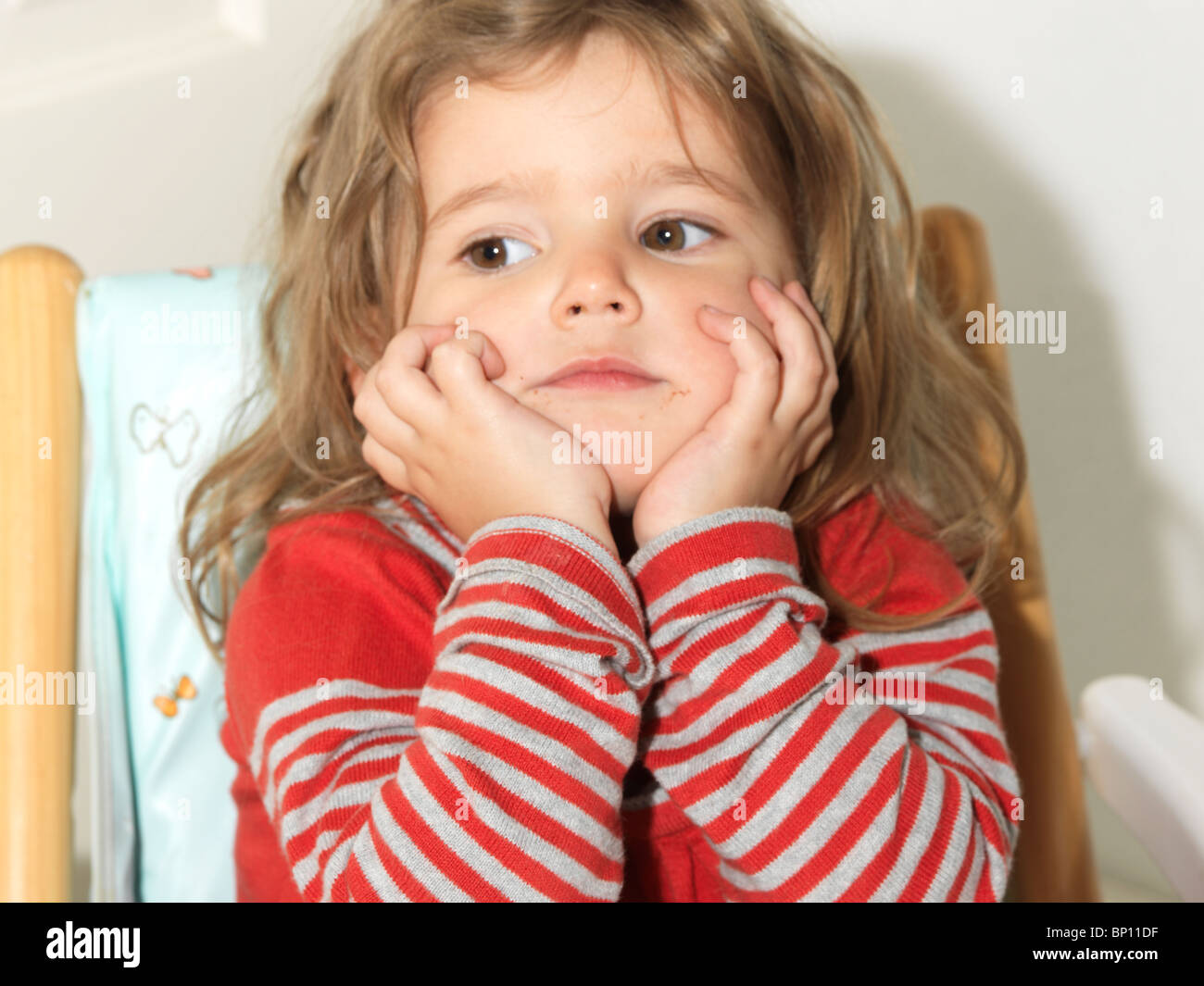 Two Year Old Girl Sitting in a High Chair Stock Photo Alamy