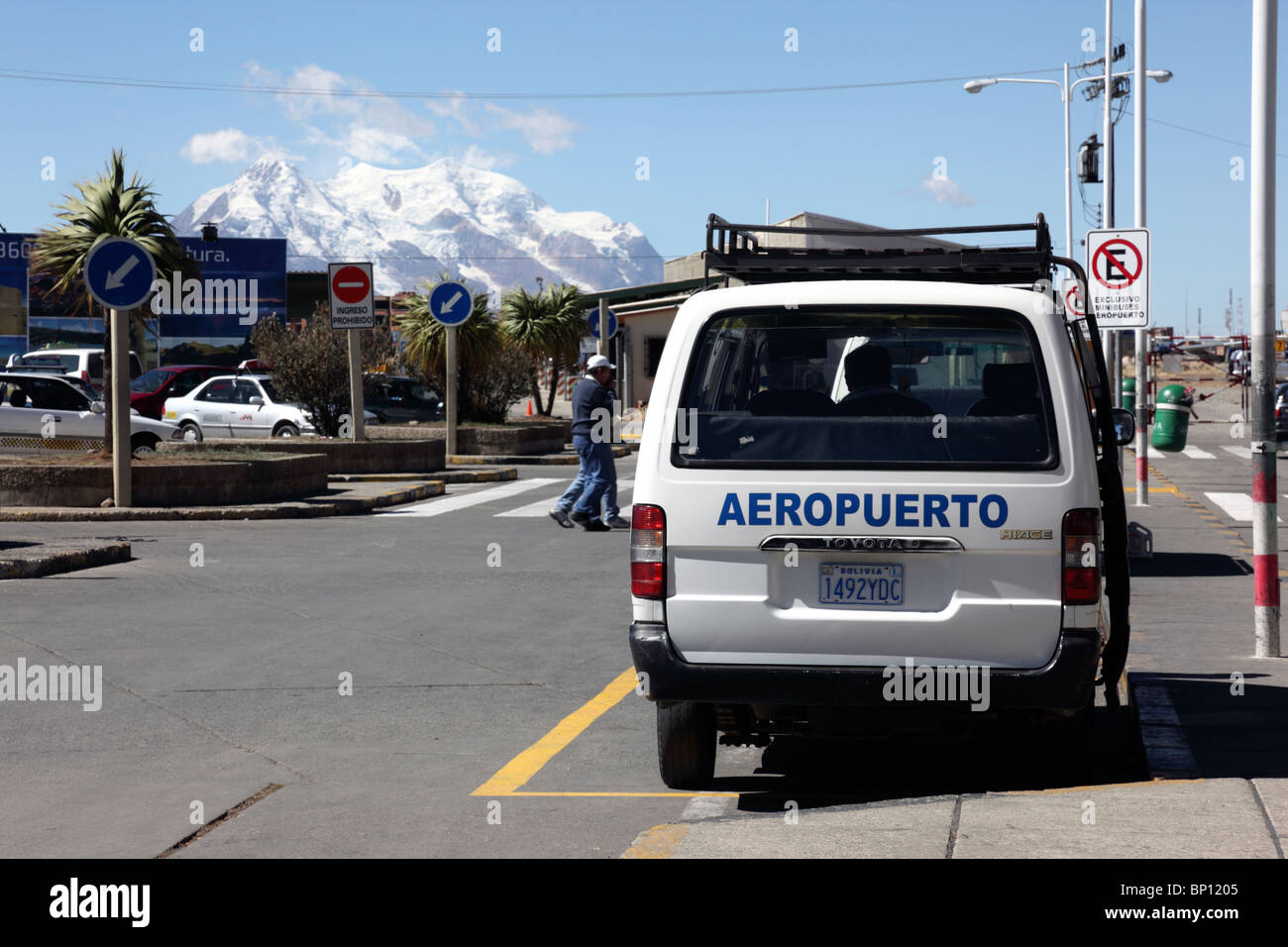 Official public transport minibus at El Alto airport (LPB, the highest international airport in the world), Mt Illimani in background, La Paz, Bolivia Stock Photo