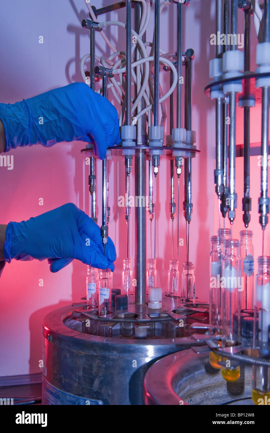 Edmonton, Alberta, Canada; Gloved Hands Put Liquid Into Test Tubes In A Laboratory Stock Photo