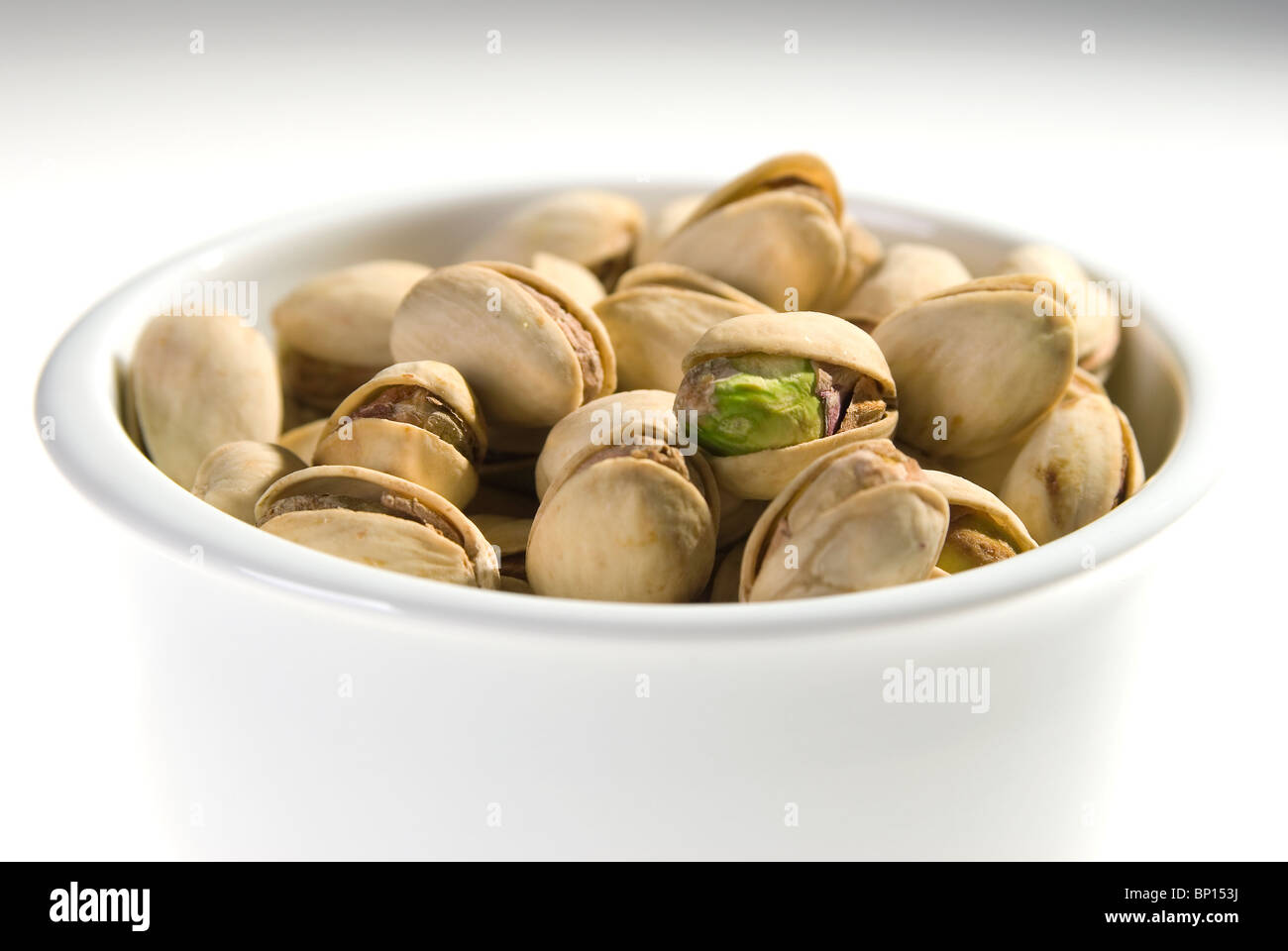 The pistachio nut closeup in porcelain basin Stock Photo