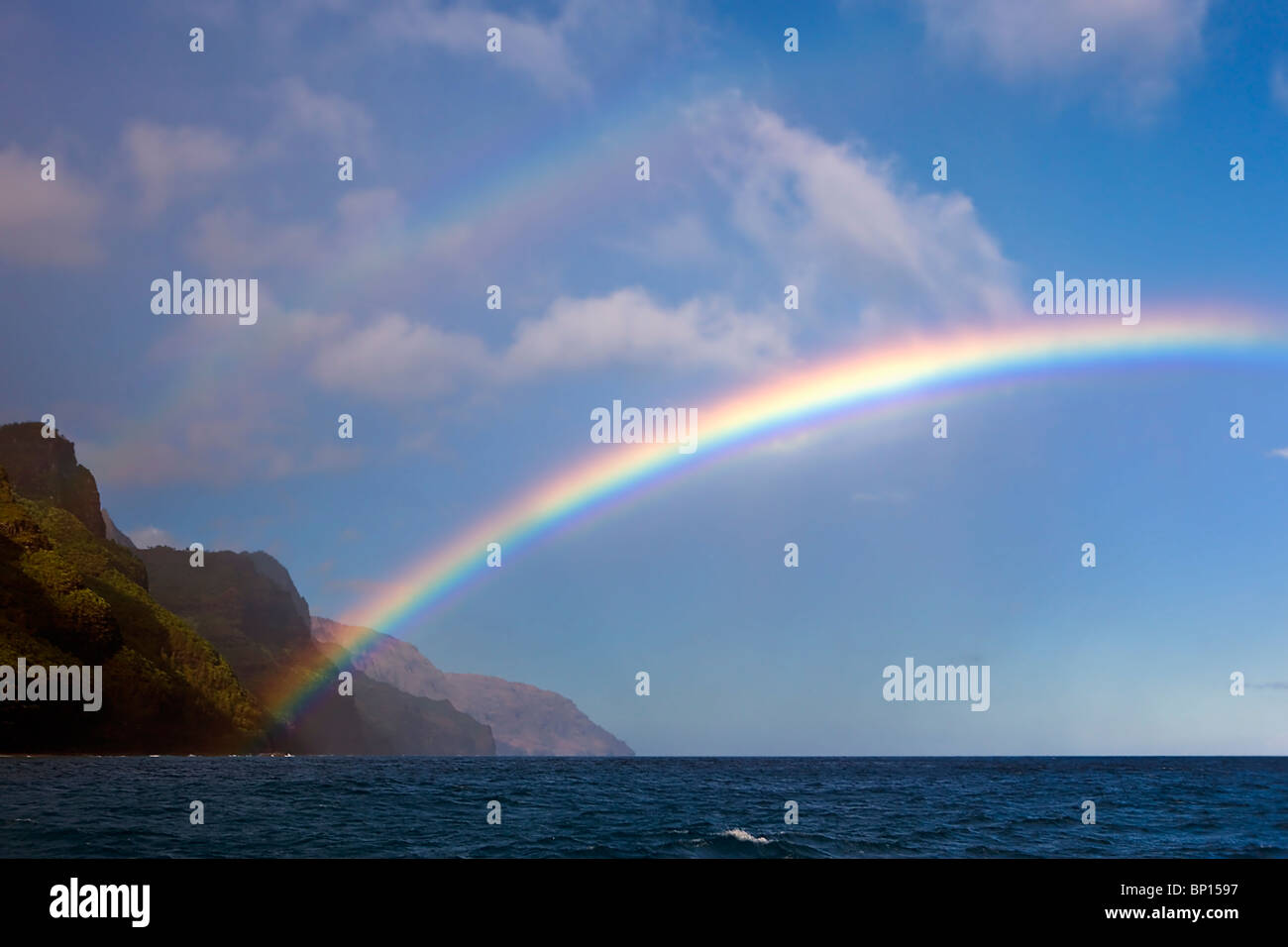 A early morning double-rainbow forms off the Na Pali coast along the island of Kauai, Hawaii, USA. Stock Photo