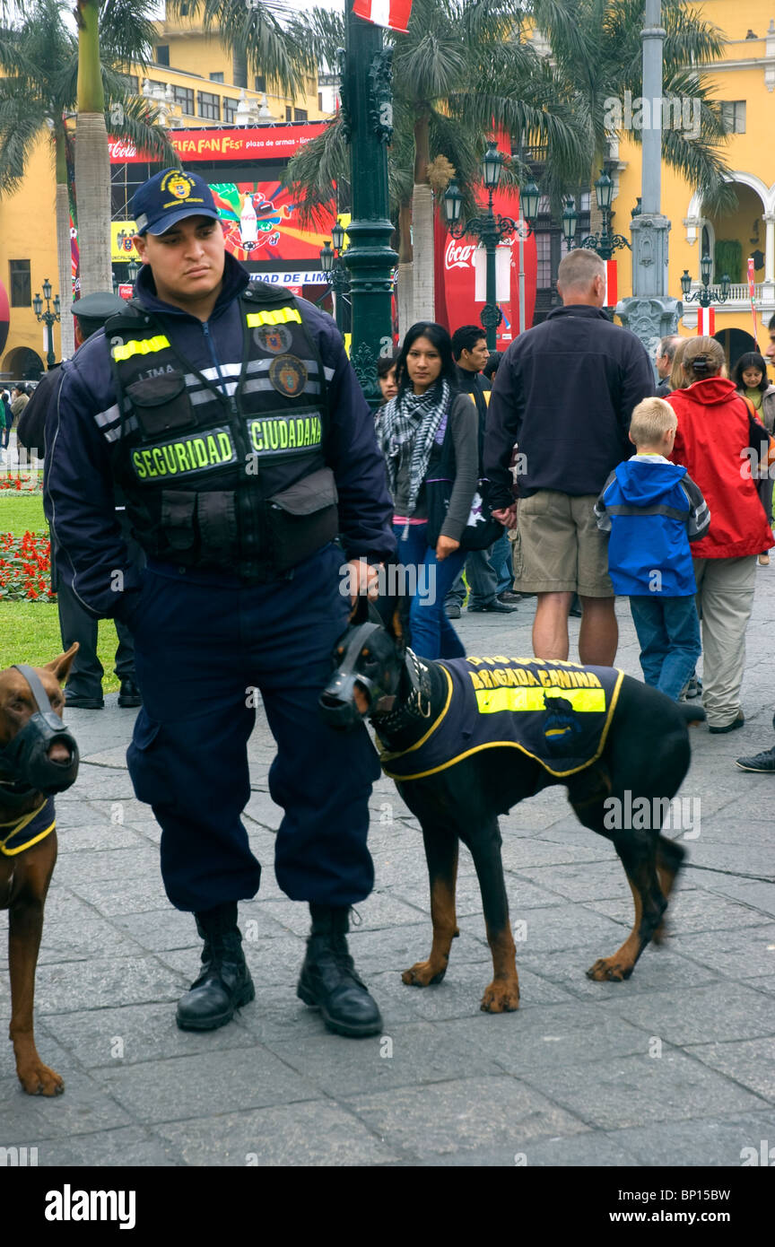 Police officer and savage dog outside the Presidential Palace in Plaza de Armas, Mayor, Lima, Peru. Stock Photo