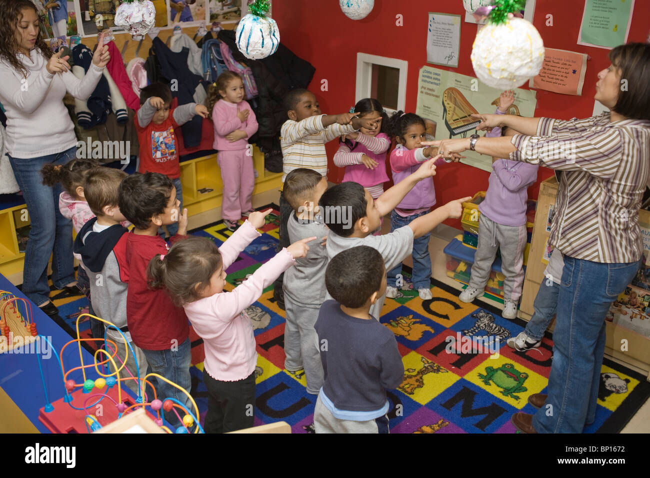 Preschool teacher and students singing Stock Photo - Alamy