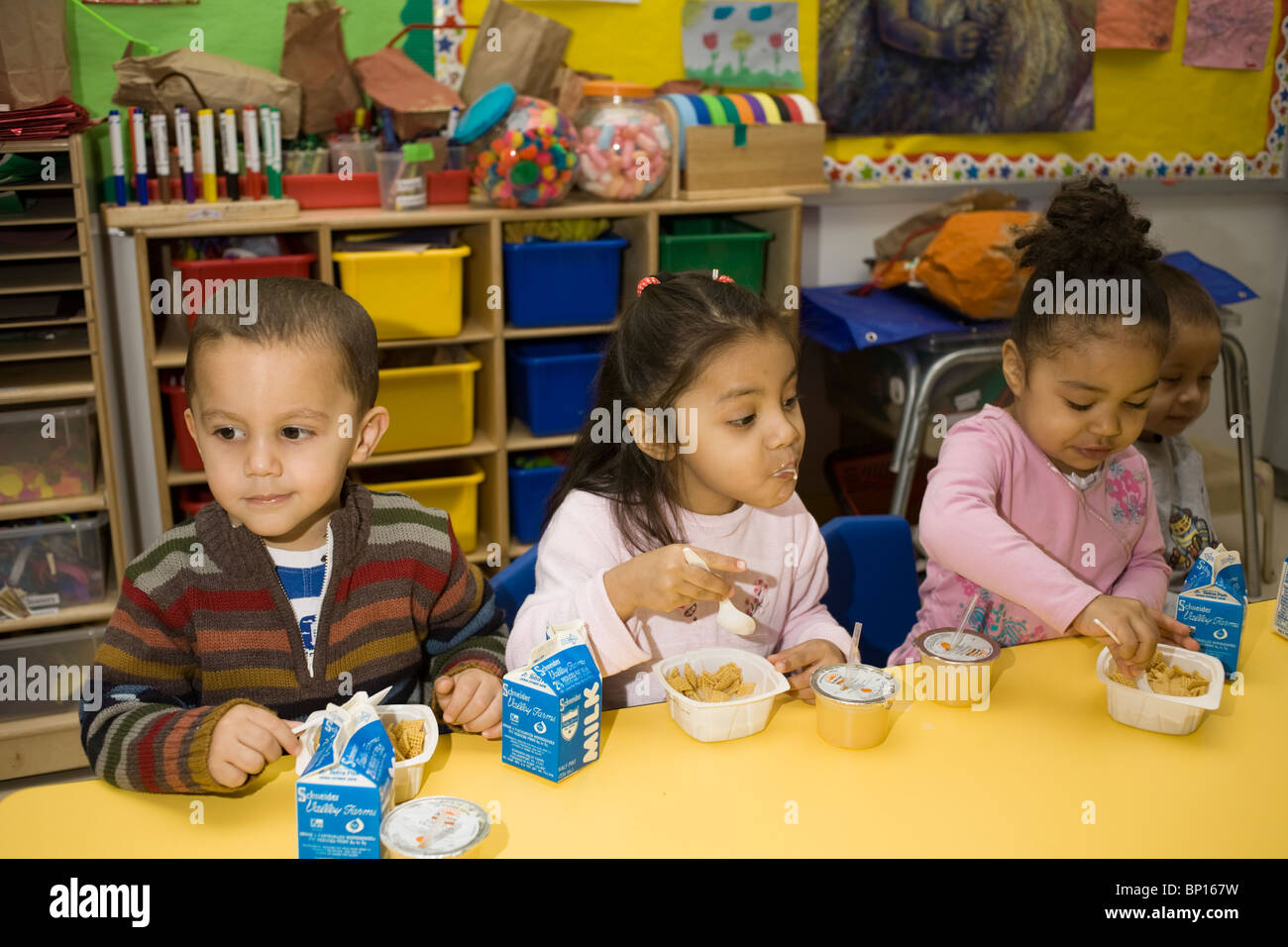 Preschool children eating breakfast in the school classroom Stock Photo