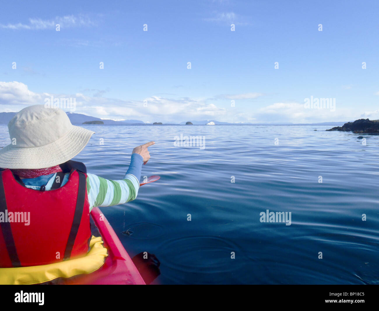 A cool kayaking experience brings this adventurer right up to an advancing glacier, paddling the Inside Passage, Alaska, USA. Stock Photo