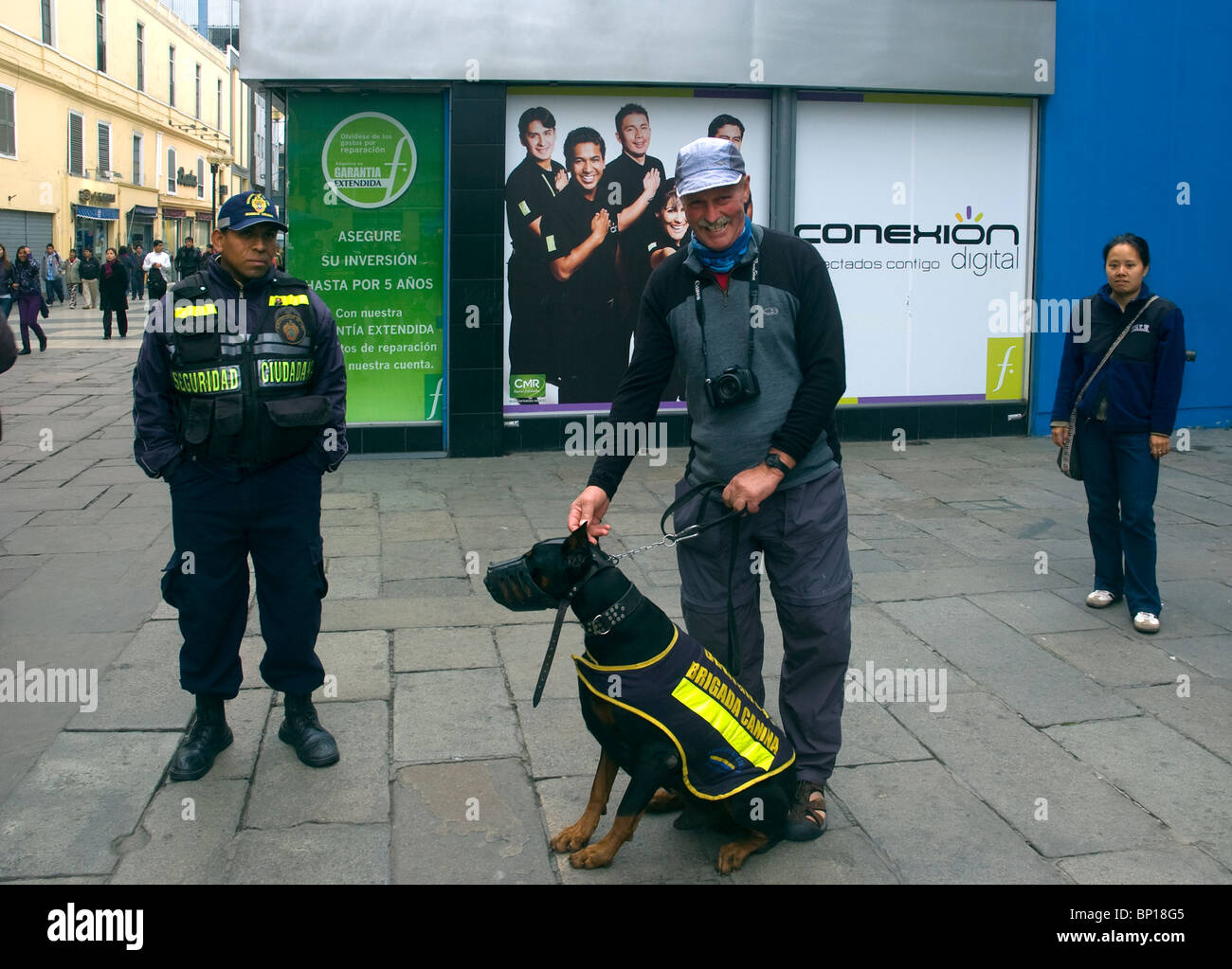 Tourist and Police officer with a savage dog on Jiron de la Union, near the Plaza de Armas, Mayor, Lima, Peru. Stock Photo