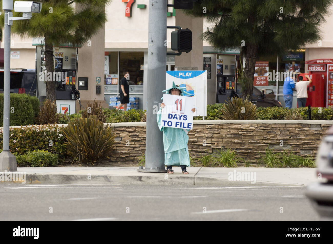 Tax Preparation: Man in Statue of Liberty Costume advertises tax preparation services. Stock Photo