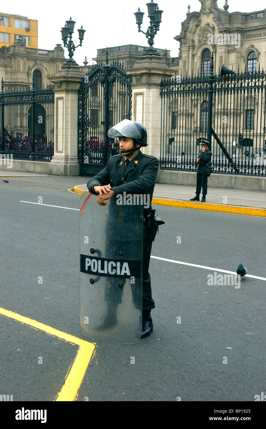 Police officer with riot shield outside the Presidential Palace in Plaza de Armas, Mayor, Lima, Peru. Stock Photo
