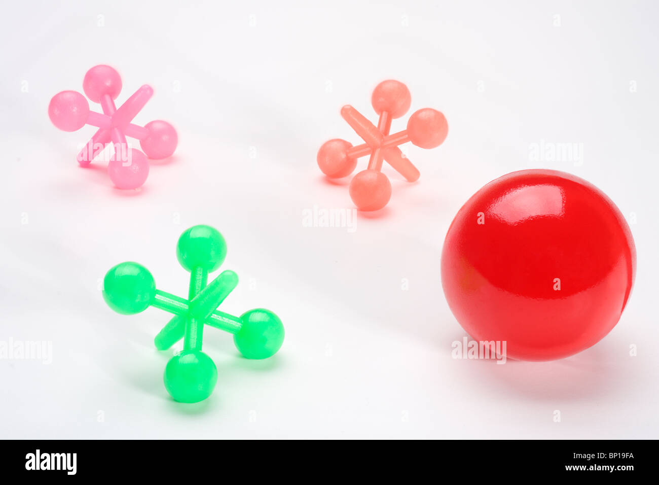 Plastic jacks and red ball Stock Photo
