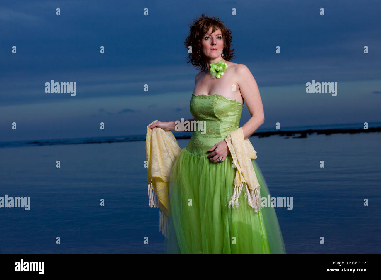 Woman in green dress by the sea hi-res stock photography and images - Alamy
