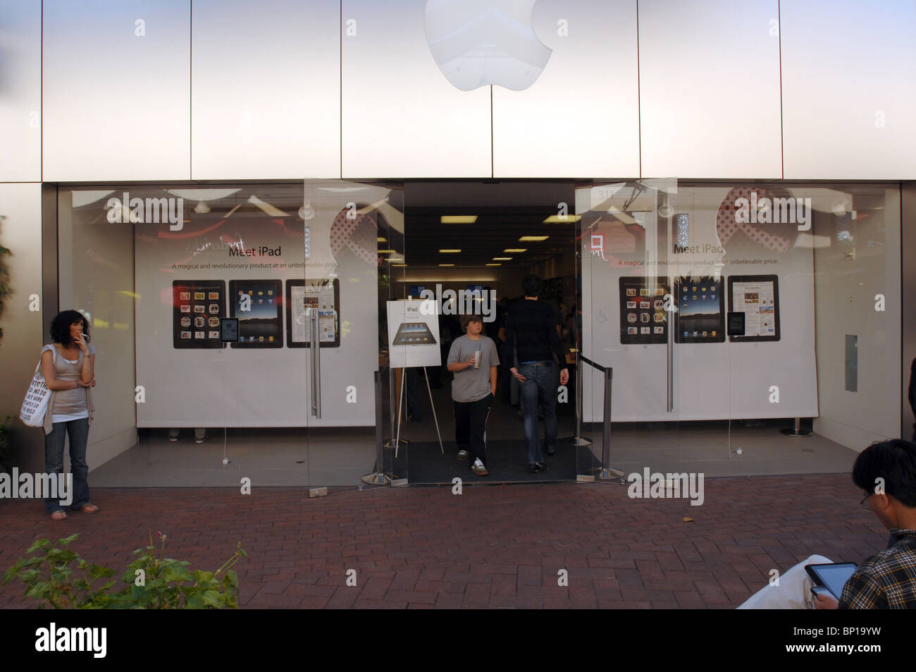 THe Apple Store in Irvine, California opens its doors to crowds of people anxious to get their