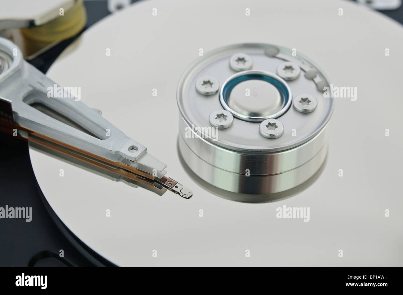 Exposed read-head, arm and platter inside a computer hard disk drive. Stock Photo