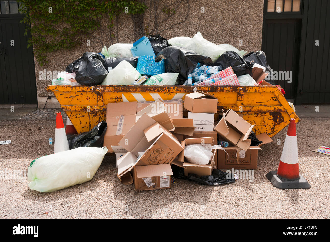 Overflowing rubbish skip Stock Photo Alamy