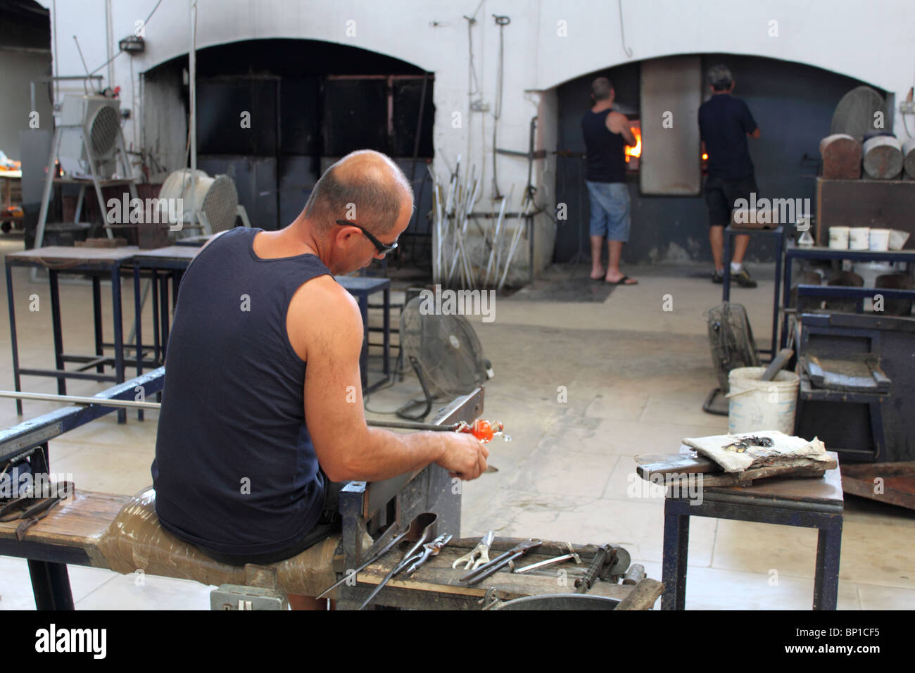 Man making glass figurines at the Mdina Glass factory, Ta Qali Crafts