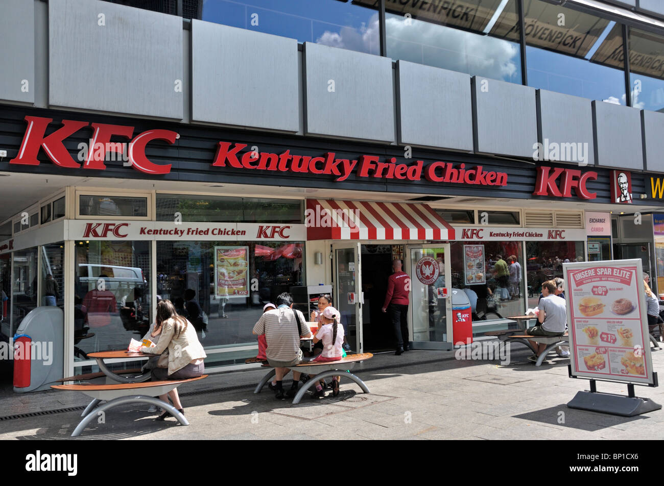 Customers eat outside a Kentucky Fried Chicken (KFC) restaurant in Berlin Germany July 2010 Stock Photo